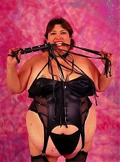 Dominatrix Looking Fat Chick Posing with Whip